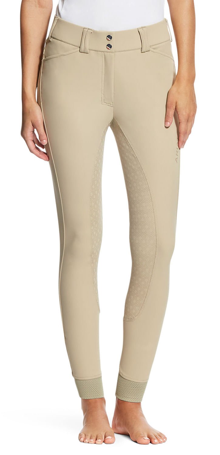 Beige riding pants worn by a person on a white background