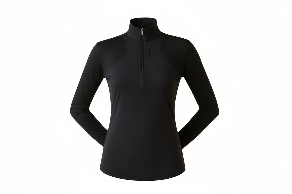 Woman wearing a black long-sleeve athletic top with a zipper, standing against a white background.