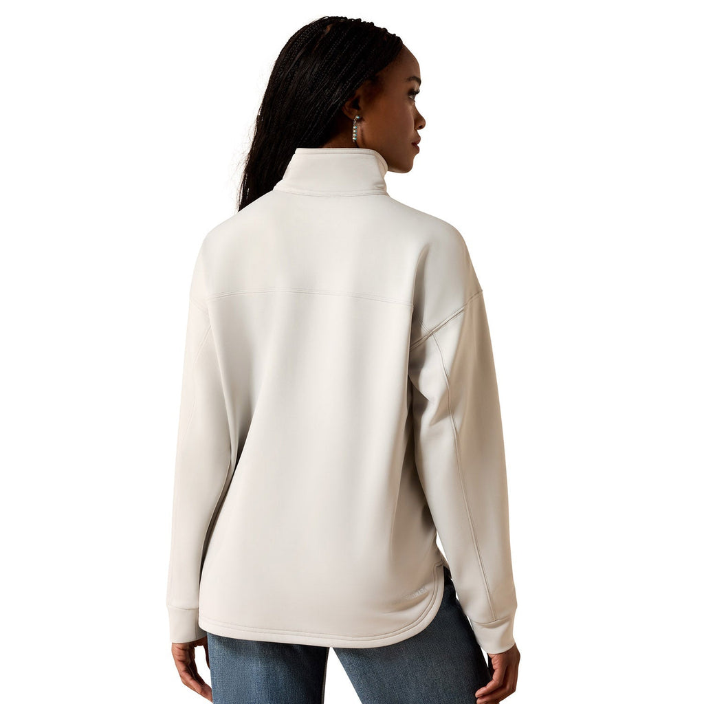 Woman wearing a beige half-zip fleece jacket on a white background