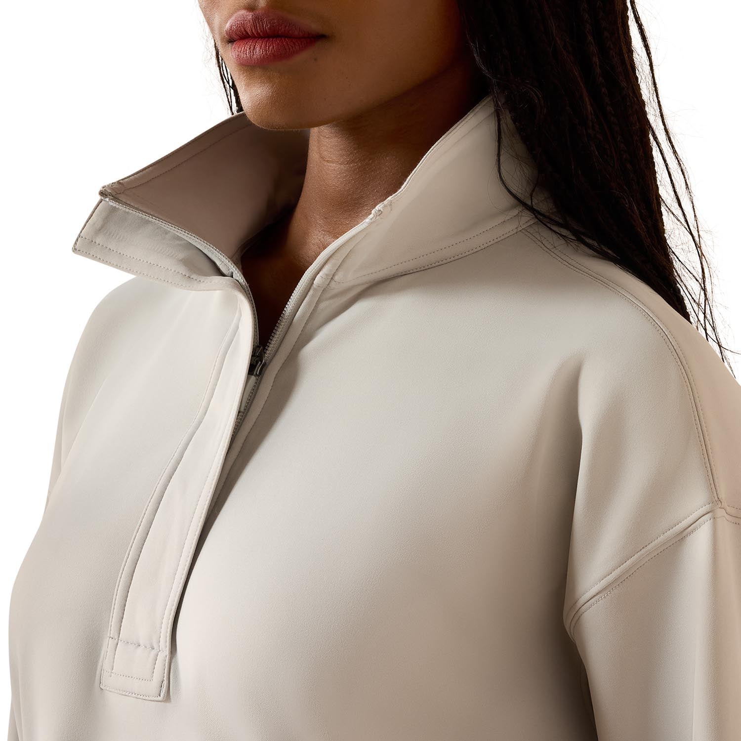 Close-up of a beige jacket with a zipper on a white background