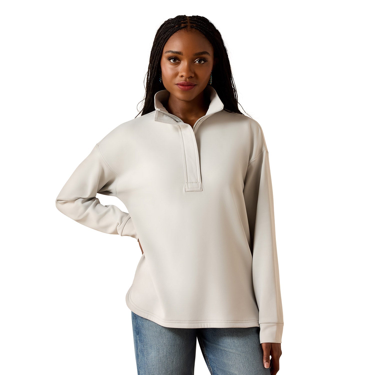 Woman wearing a beige long-sleeve shirt with a quarter zip on a white background