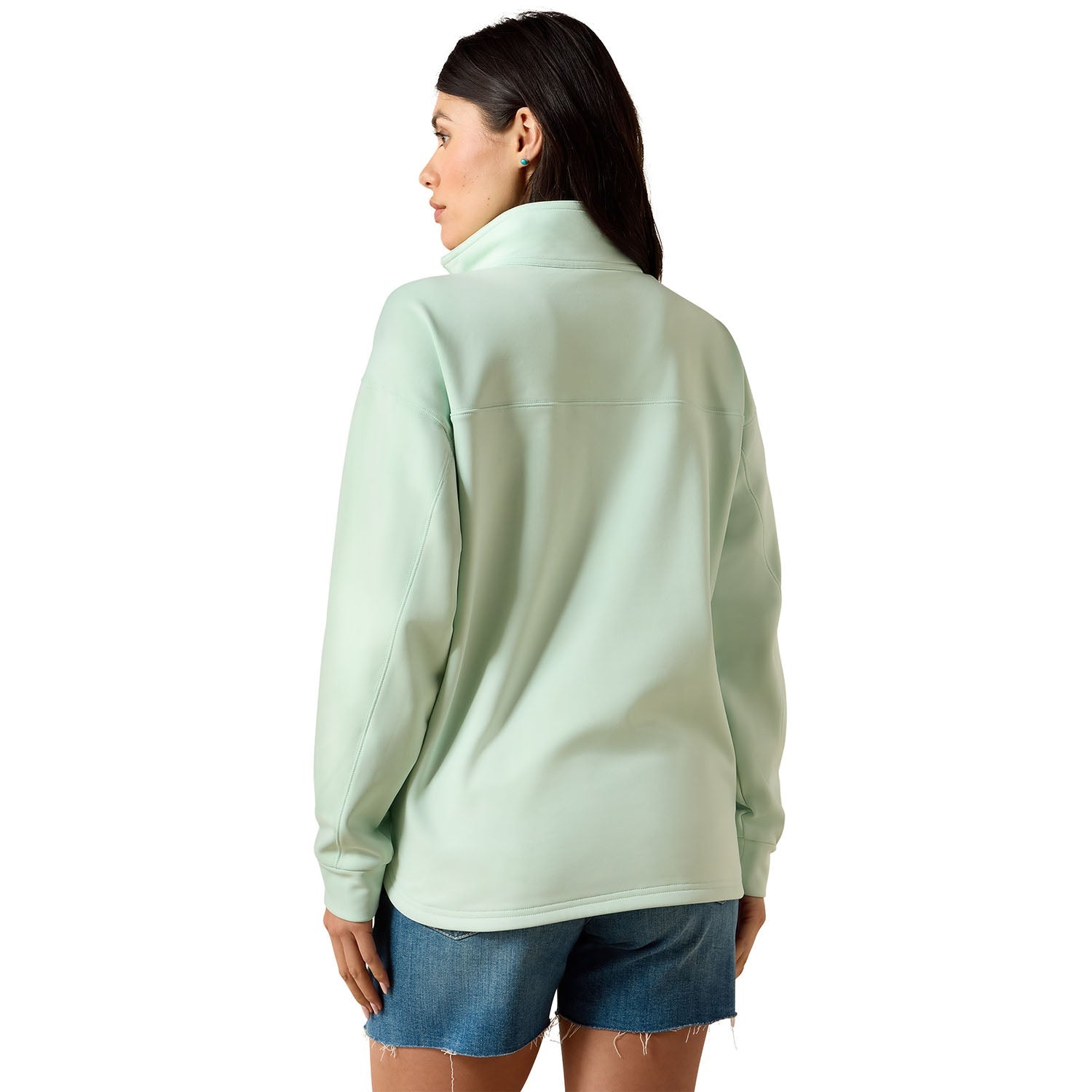 Person wearing a light green fleece jacket on a white background