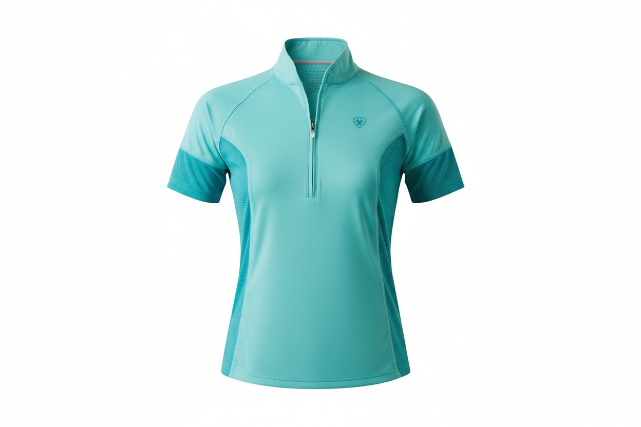 Woman wearing a turquoise athletic shirt and black cap on a white background