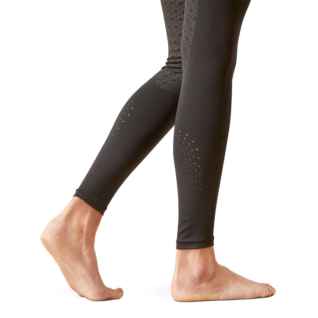 Black leggings with subtle pattern worn by a person on a white background