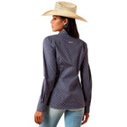 Woman wearing a patterned shirt and straw hat on a white background
