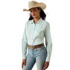 Woman wearing a light blue striped shirt, jeans, and a cowboy hat on a white background