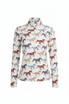 Woman wearing a patterned long-sleeve shirt with horse design on a white background