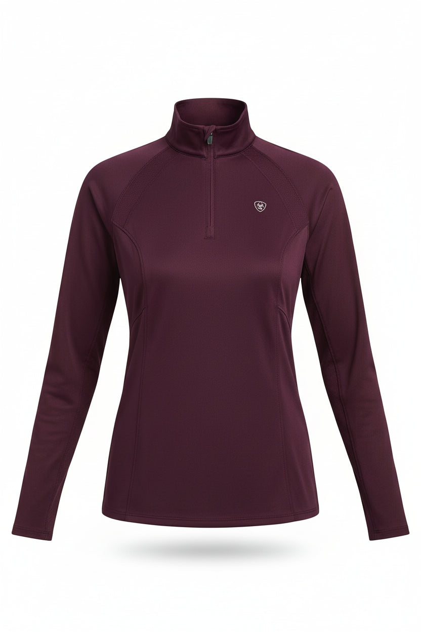 Woman wearing a purple long-sleeve athletic shirt with a logo on a white background