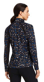 Woman wearing a patterned long-sleeve shirt with a white background