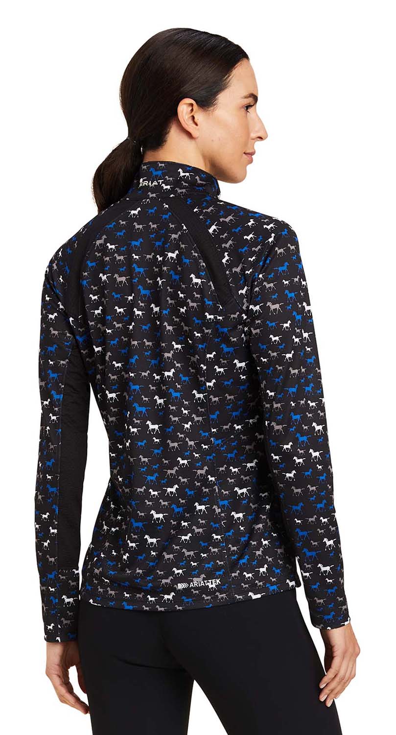Woman wearing a patterned long-sleeve shirt with a white background