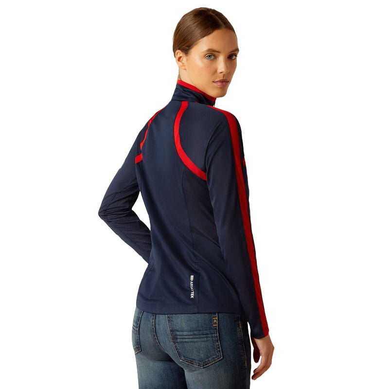 Woman wearing a navy jacket with red accents on a white background