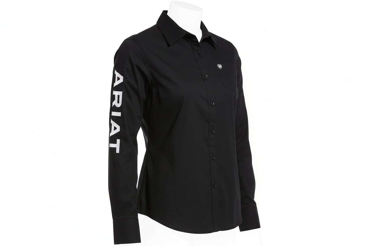 Person wearing a black shirt with 'Ariat' branding on a white background