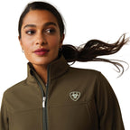 Woman wearing a brown jacket with a logo on a white background