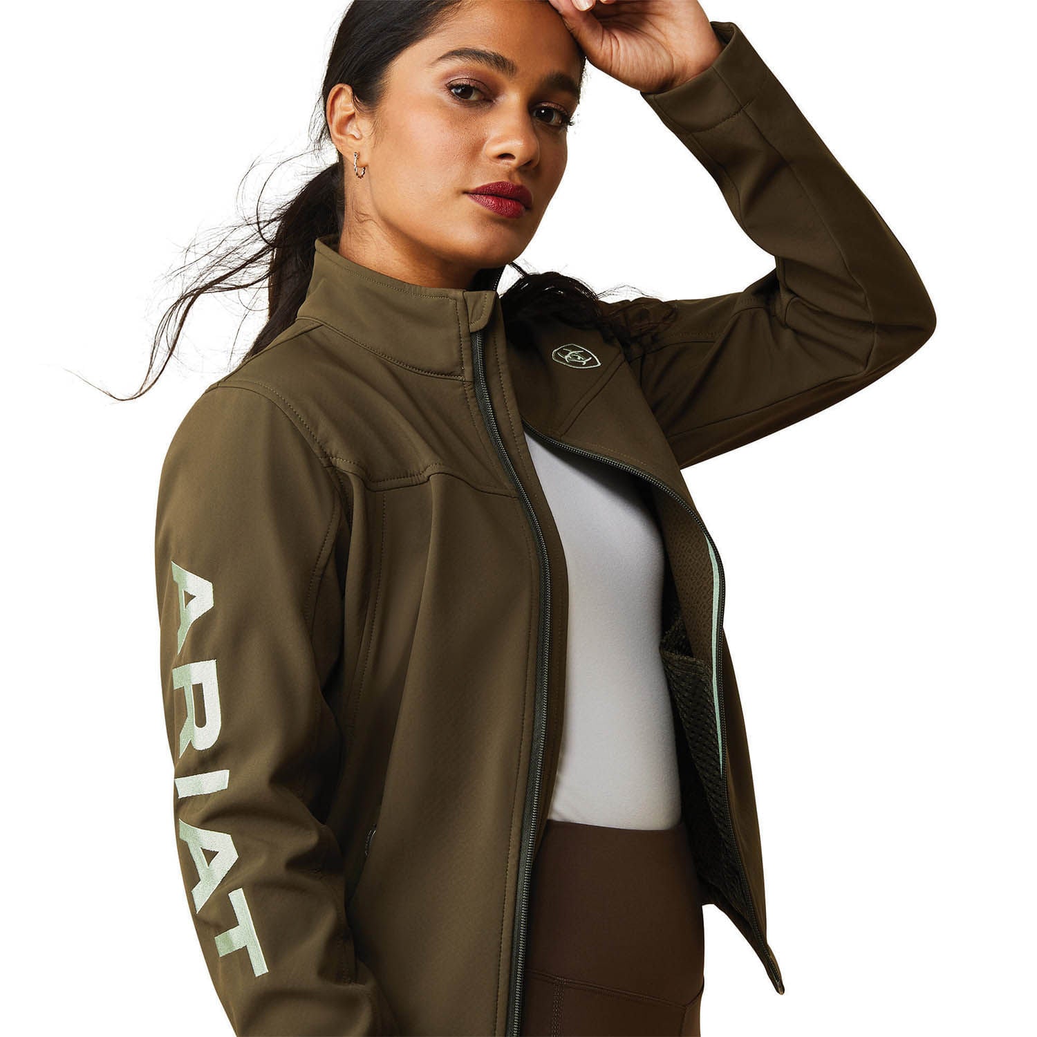 Woman wearing a brown Ariat jacket on a white background