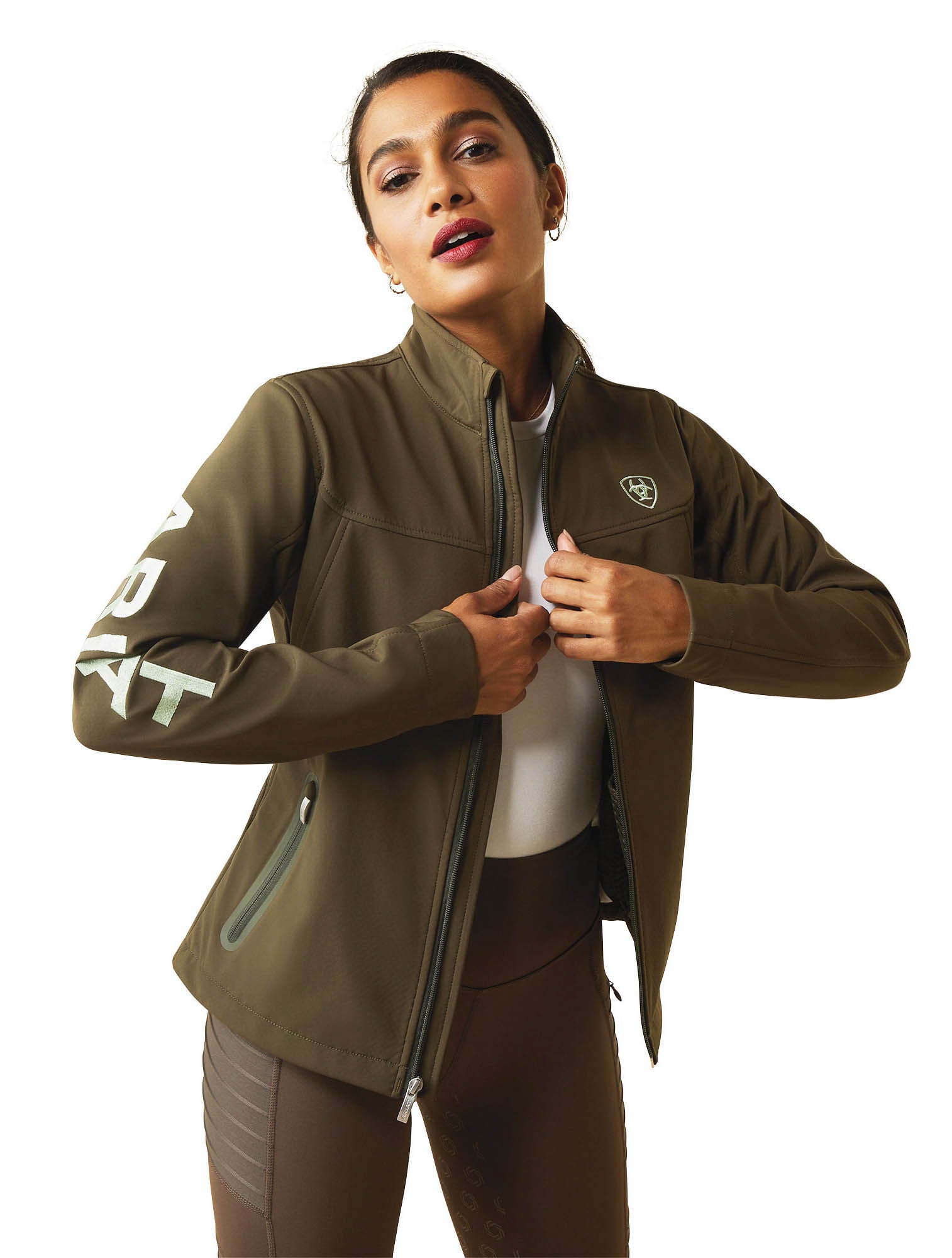 Woman wearing a green jacket with a brand logo on a white background