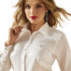 Woman wearing a white shirt with a plain background