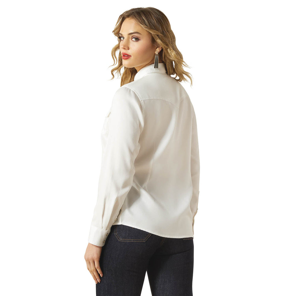 Woman wearing a white blouse and dark jeans on a white background