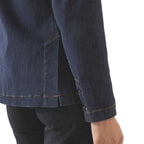 Close-up of a dark blue denim jacket on a white background