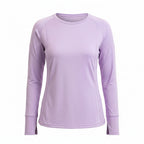 Woman wearing a light purple long-sleeve top with colorful leggings on a white background