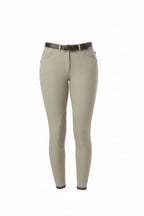 Person wearing beige riding pants with a white top on a white background