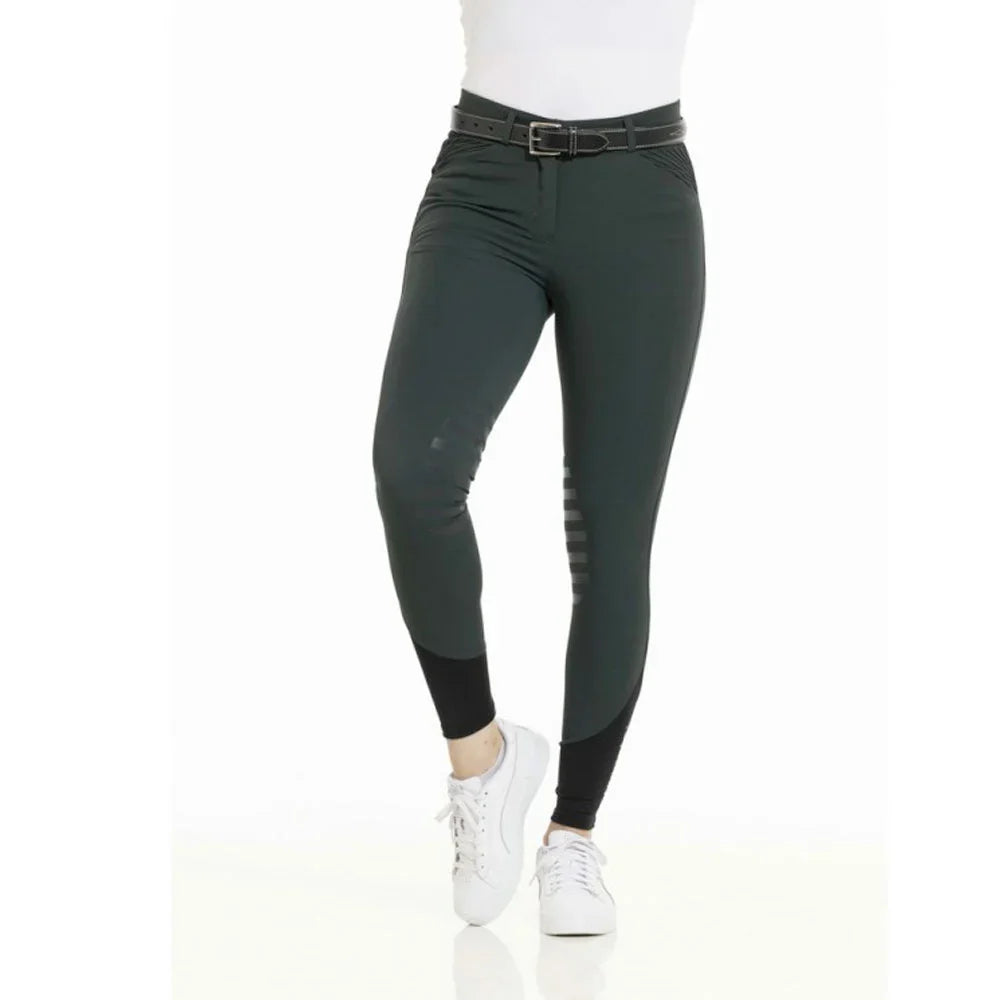 Dark green leggings worn by a person on a white background