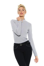 Woman wearing a gray long-sleeve top and black pants on a white background