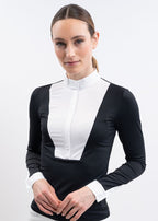 Woman wearing a black and white long-sleeve equestrian competition top against a white background