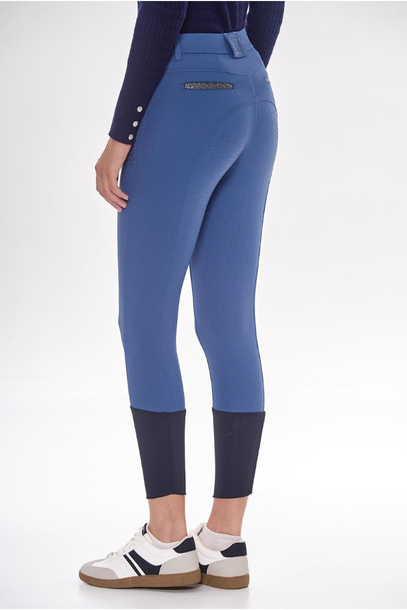 Blue riding pants with a white background