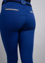 Blue riding pants with a visible brand logo on a gray background