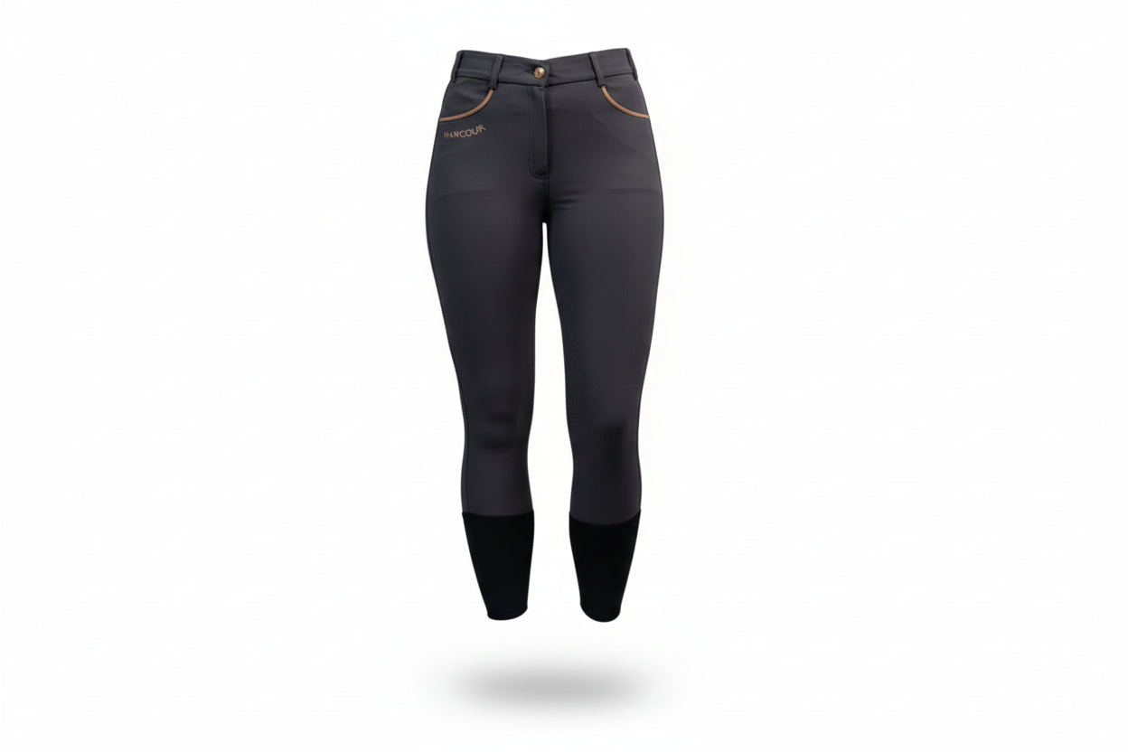  dark gray riding pants with white sneakers on a gray background