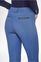 Blue riding pants with a textured pattern on a white background