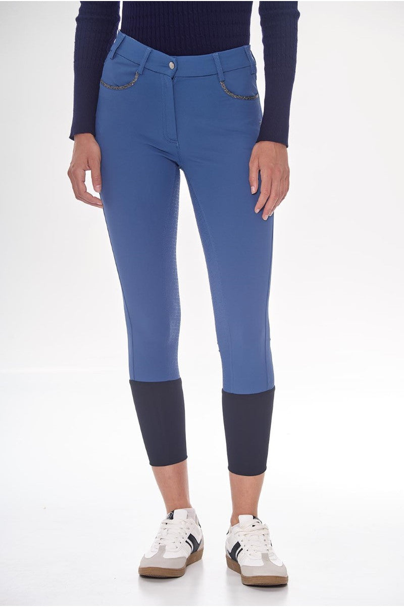 Blue riding pants with dark cuffs and hem on a white background