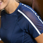 Person wearing a navy blue athletic shirt with white stripes on a blurred background