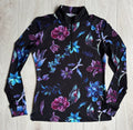 Black long-sleeve shirt with colorful floral pattern on a light wooden surface