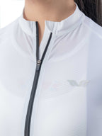Close-up of a white jacket with a zipper and a logo on the chest.