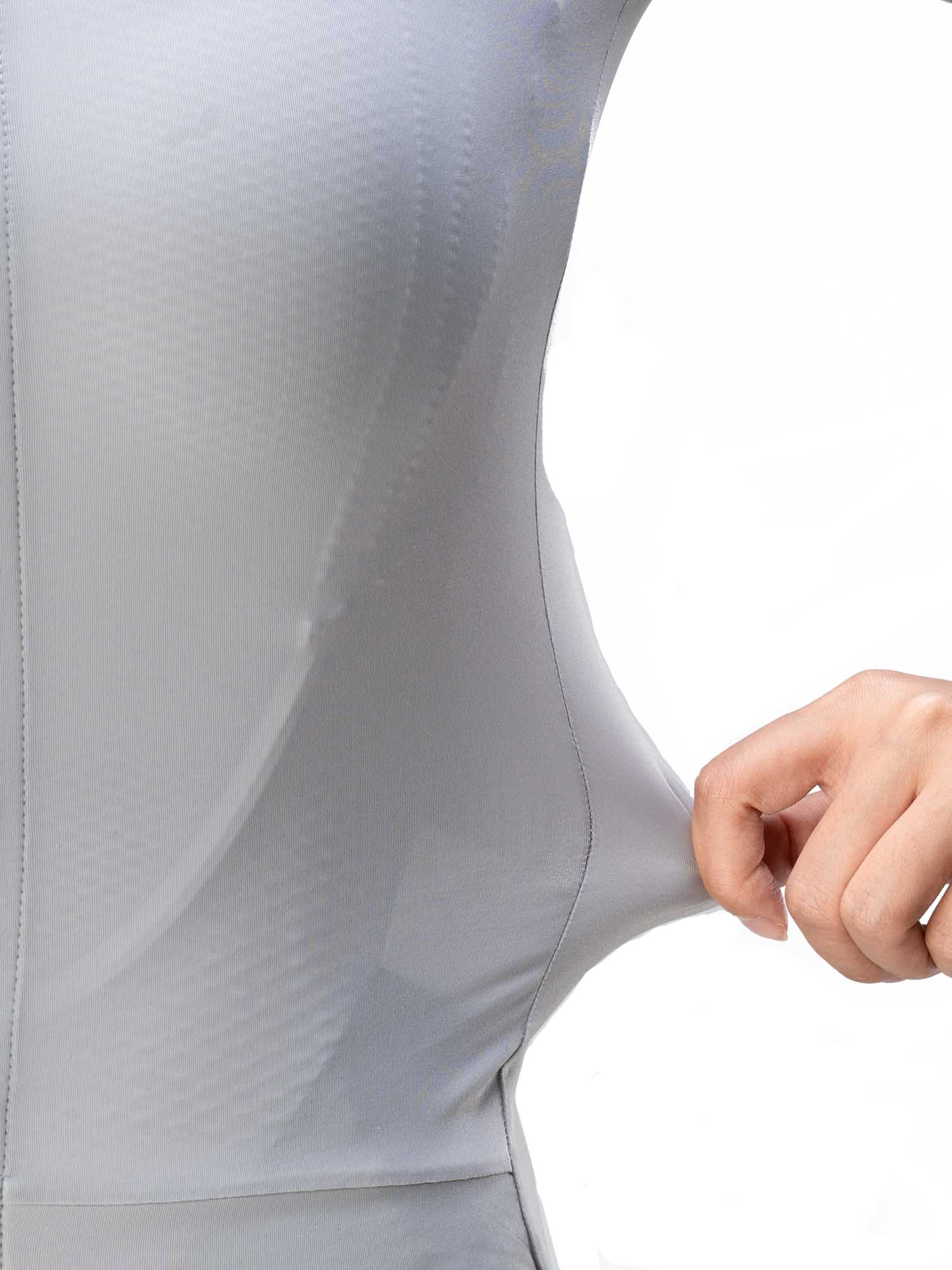 Close-up of a person wearing a light gray bodysuit with a hand adjusting the fabric.