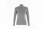 Woman wearing a gray turtleneck and white pants on a white background
