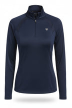 Woman wearing a navy long-sleeve top and pants with a belt, on a white background