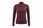 Woman wearing a maroon long-sleeve athletic top with a small logo on a white background