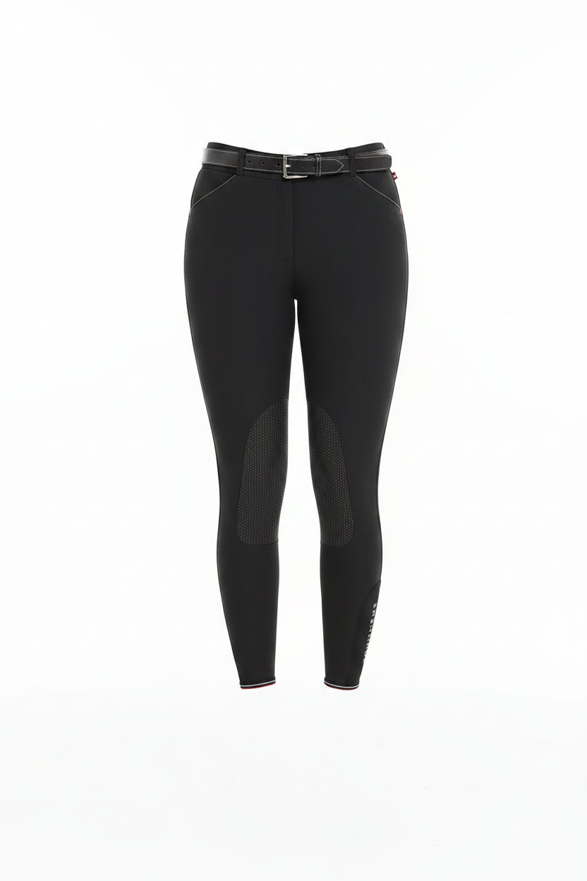 Person wearing black riding pants on a white background